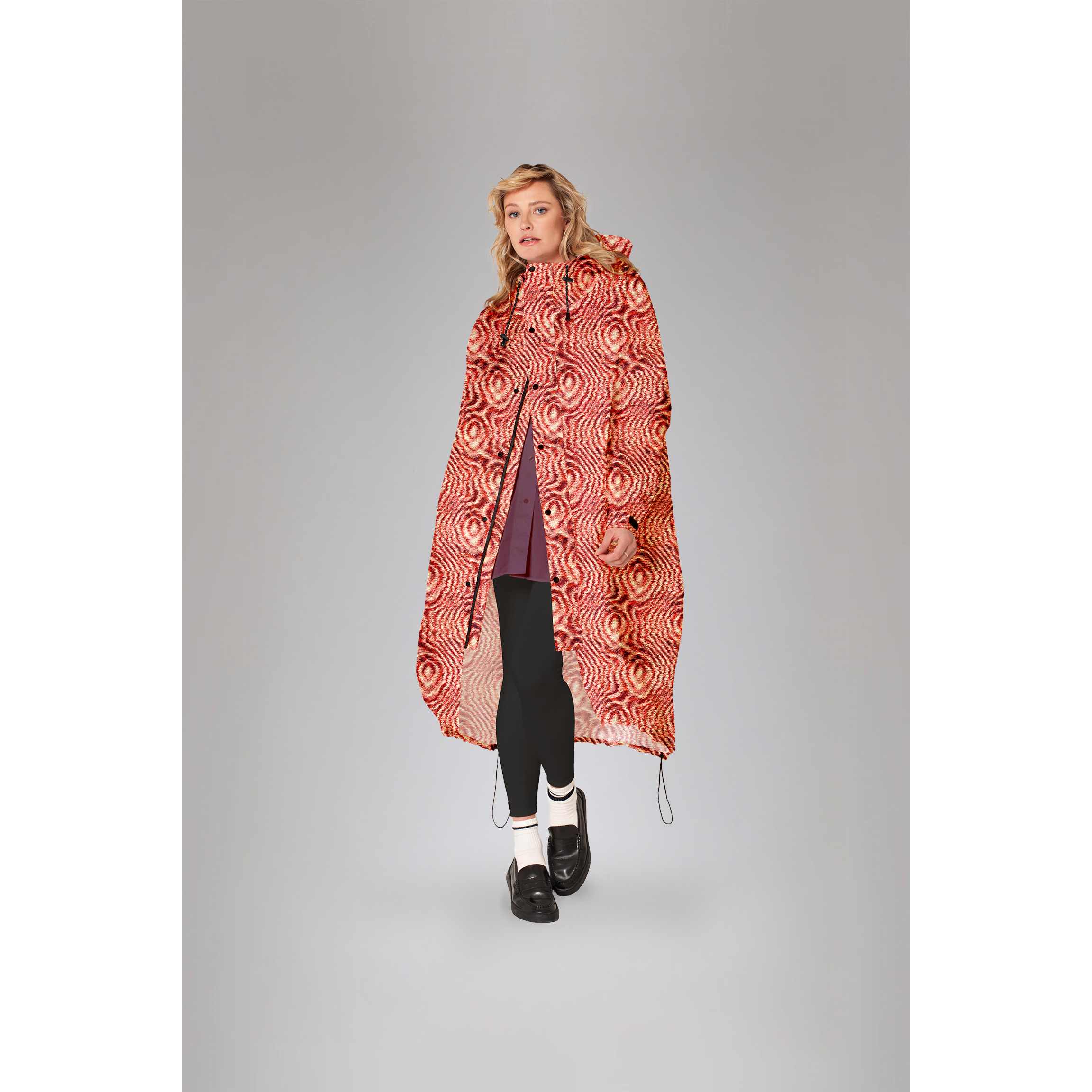 Rainkiss Moiré orange raincoat with abstract print; model wearing the coat, front view.