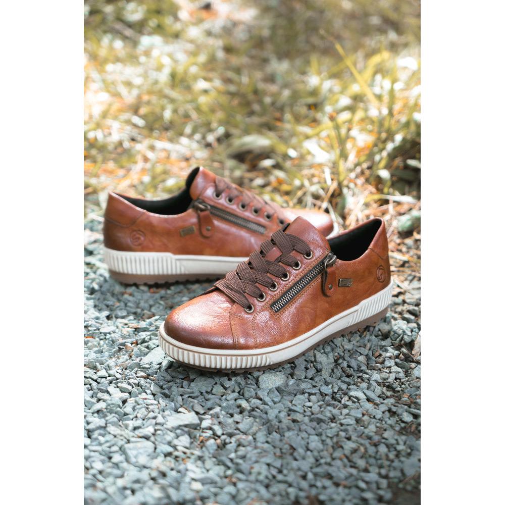 Remonte D0700-22 women's wide brown leather water-resistant shoes with zip and lace closures on gravel outdoor path.