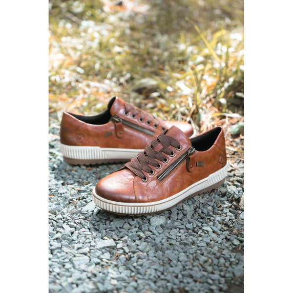 Remonte D0700-22 women's wide brown leather water-resistant shoes with zip and lace closures on gravel outdoor path.