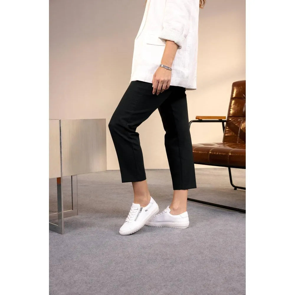 White leather zip and lace shoes with water-resistant finish, styled with black pants and a cream blazer.