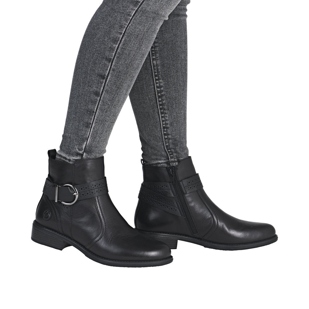 Remonte D0F81-00 women's black leather ankle boots with side zipper, low heel, and decorative strap with metal buckle.