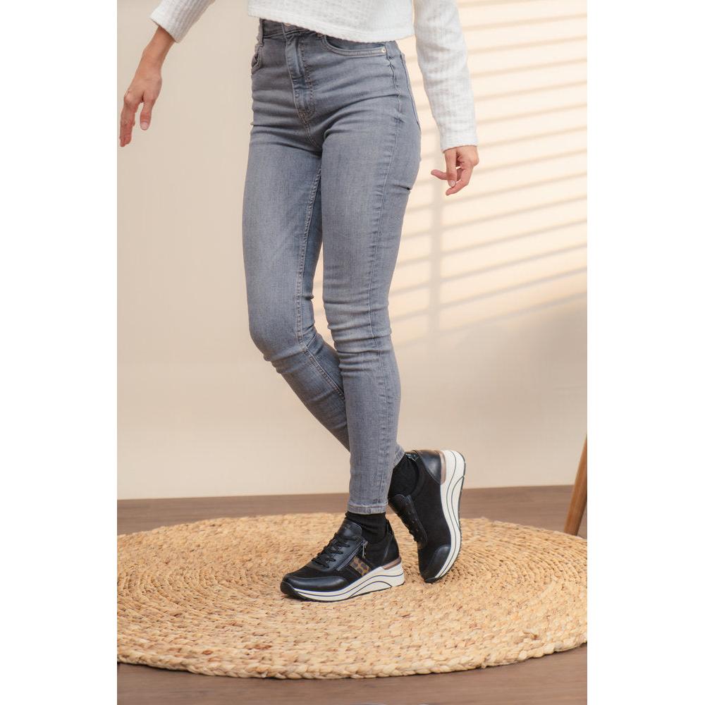 Remonte D0T09-04 women's wide-fit black vegan zip and lace sneakers, stylish and comfortable footwear with chunky sole on a beige rug.