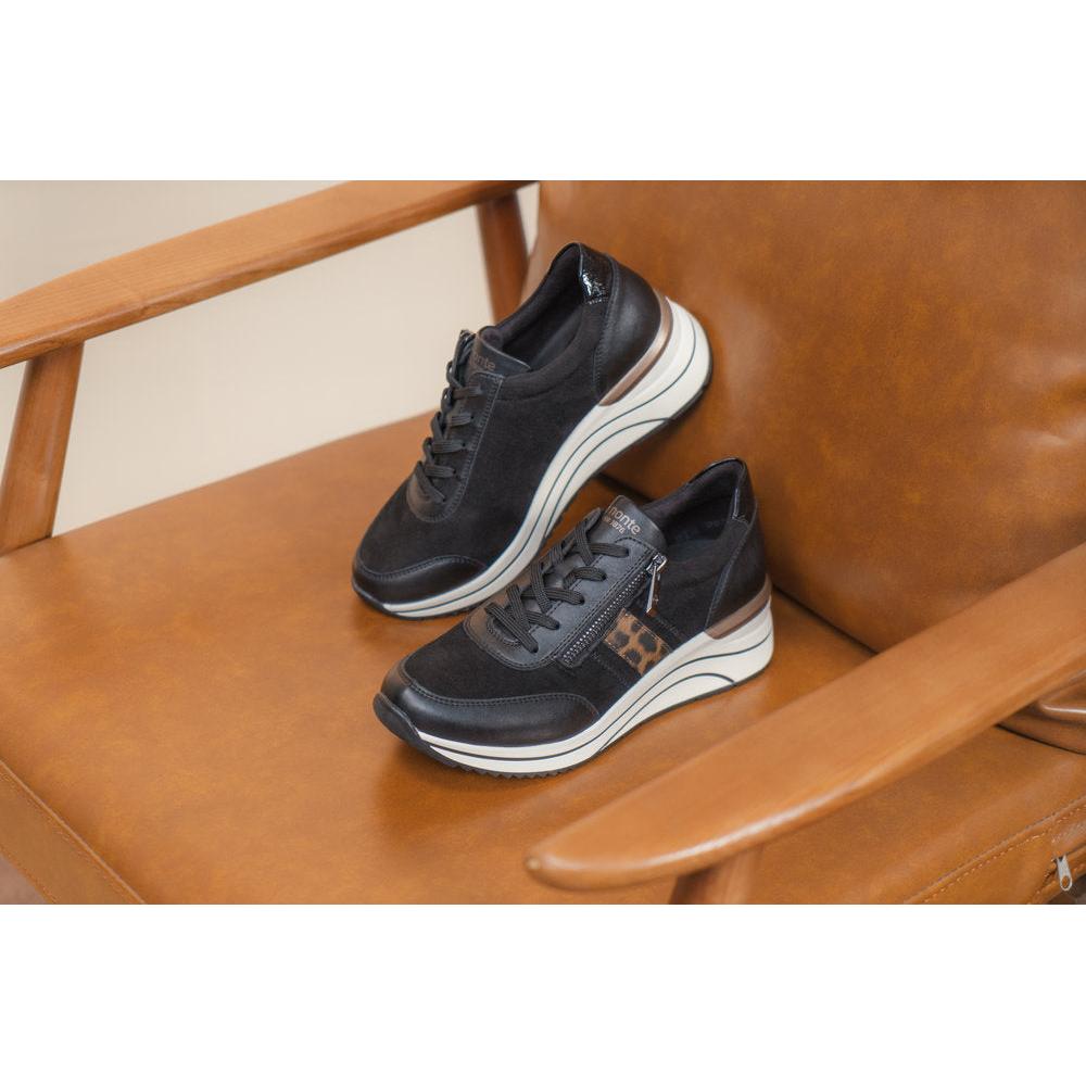 Remonte D0T09-04 women's wide black vegan shoes with zip and lace, featuring chunky white platform soles, on brown leather couch.