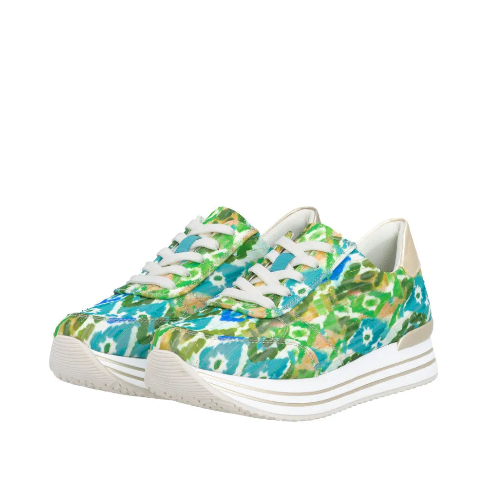 Green multi-patterned lace-up shoes with white soles, textured material, and beige heel details.