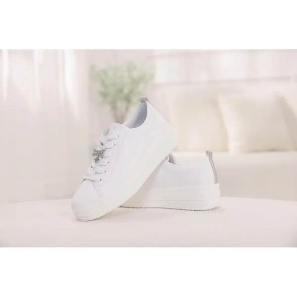 White leather lace-up shoes with chunky soles and bow-detail laces for women.