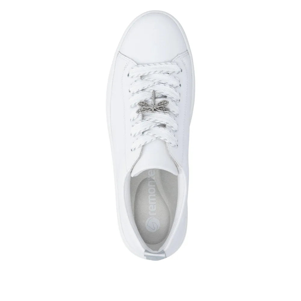 White leather lace-up shoes for women with a decorative metallic bow on the laces, rounded toe, and cushioned interior.