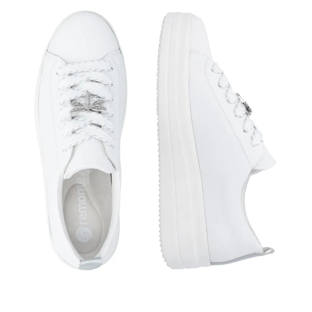 White leather lace-up shoes for women with a chunky sole and silver decorative details on the laces.