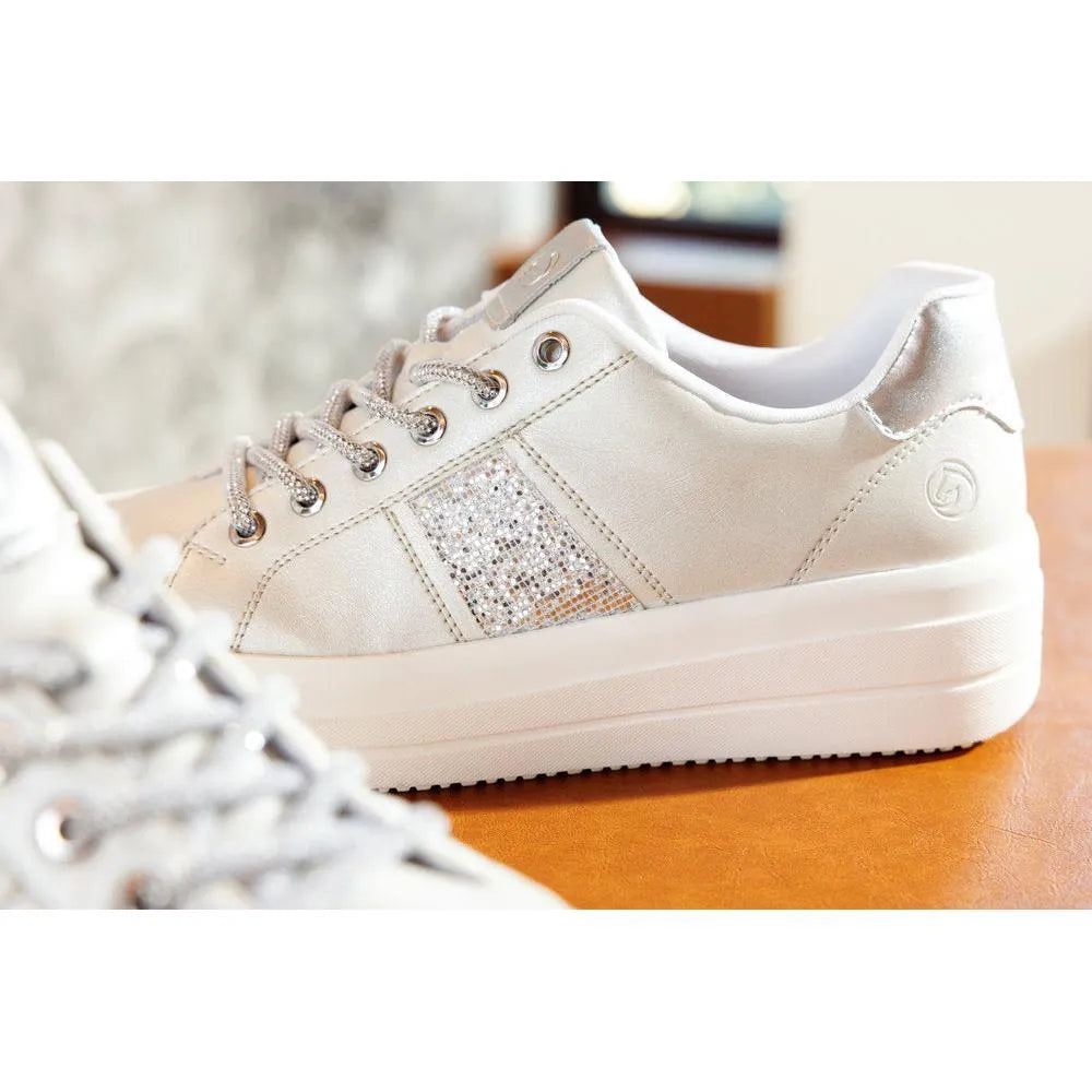 Off-white vegan sneakers with silver glitter accents, elasticated sides, lace-up design, and thick platform sole.