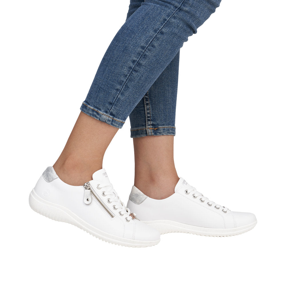 Remonte D1E03-80 women's wide white leather sneakers with zip and lace closure, silver accents, and comfortable flat sole.