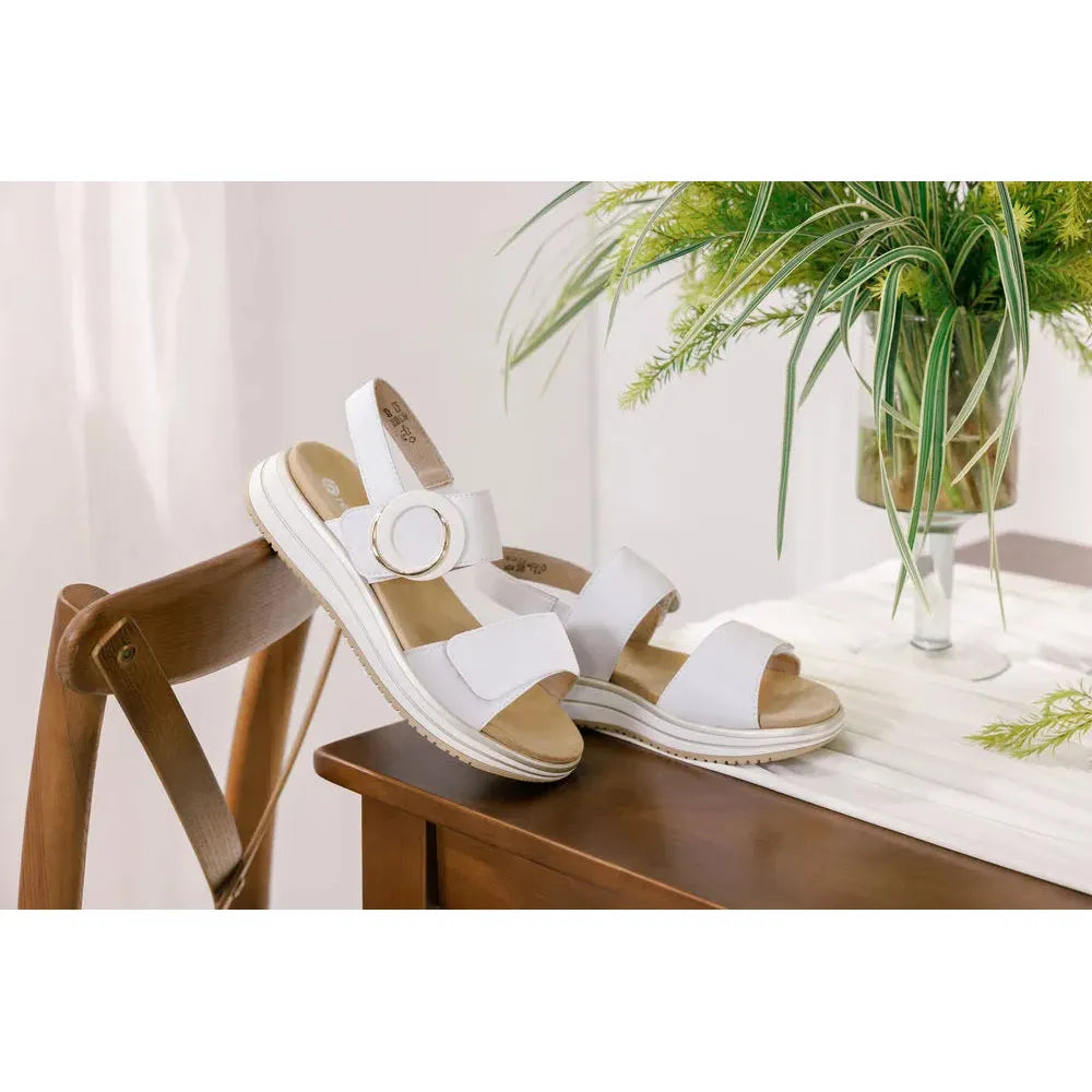 Remonte D1J63-80 women's white leather sandals with touch fastening and cushioned soles on wooden chair.