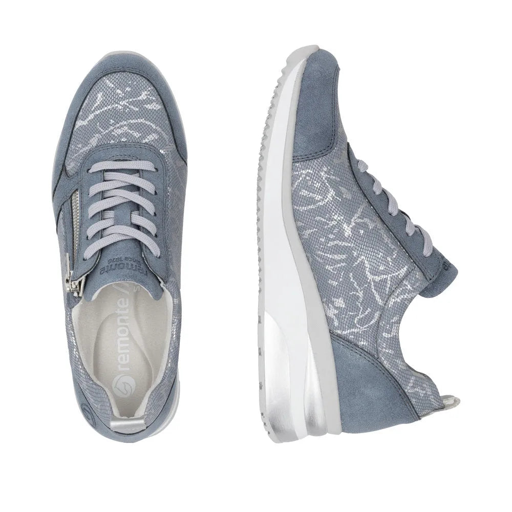 Blue textile women's sneakers with side zipper, lace-up front, and white sole, featuring floral patterns and suede accents.
