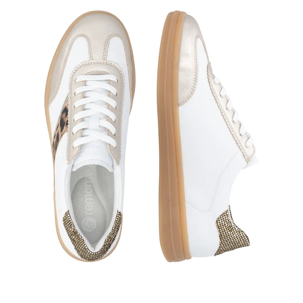 White lace-up trainers with leopard accents, metallic gold detailing, and a flexible rubber sole. Stylish and comfortable design.