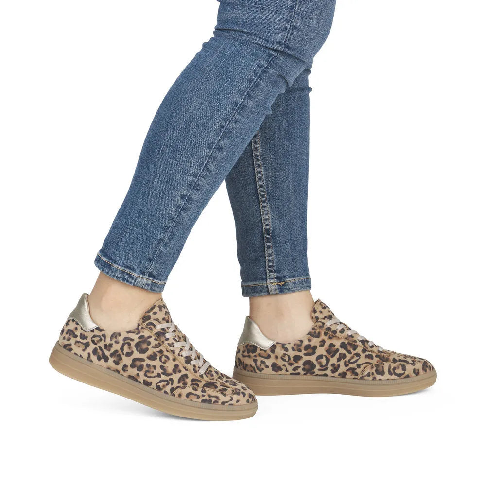 Leopard print shoes worn with blue jeans on a white background
