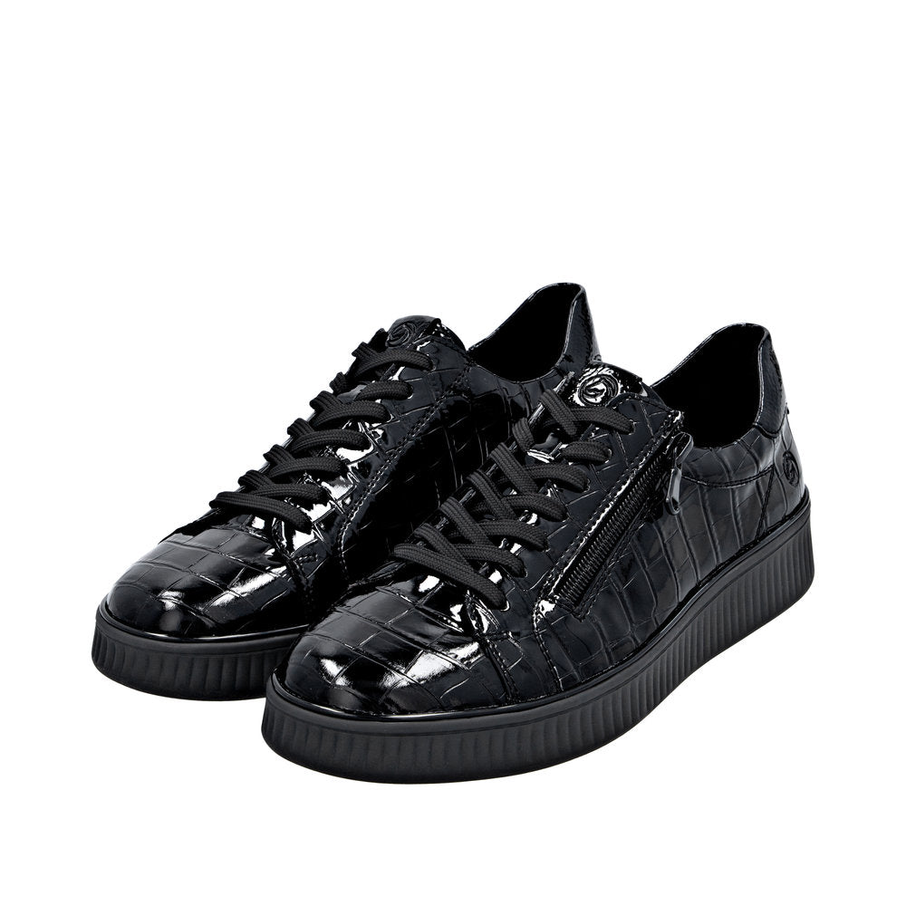 Black patent leather women's sneakers with side zippers, lace-up closure, and chunky rubber soles.