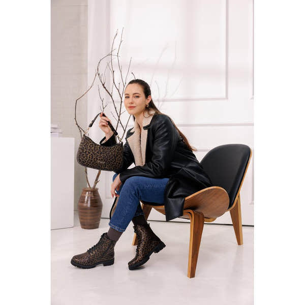 Remonte D2S72-90 women's wide fit animal print vegan ankle boots with zip and lace-up design, paired with jeans and a leather jacket.