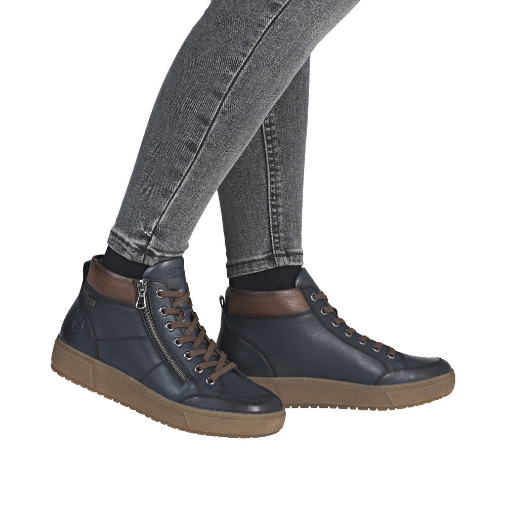 Remonte D2T70-14 women's navy leather ankle boots with water-resistant design, zip and lace-up closure, and tan rubber sole.