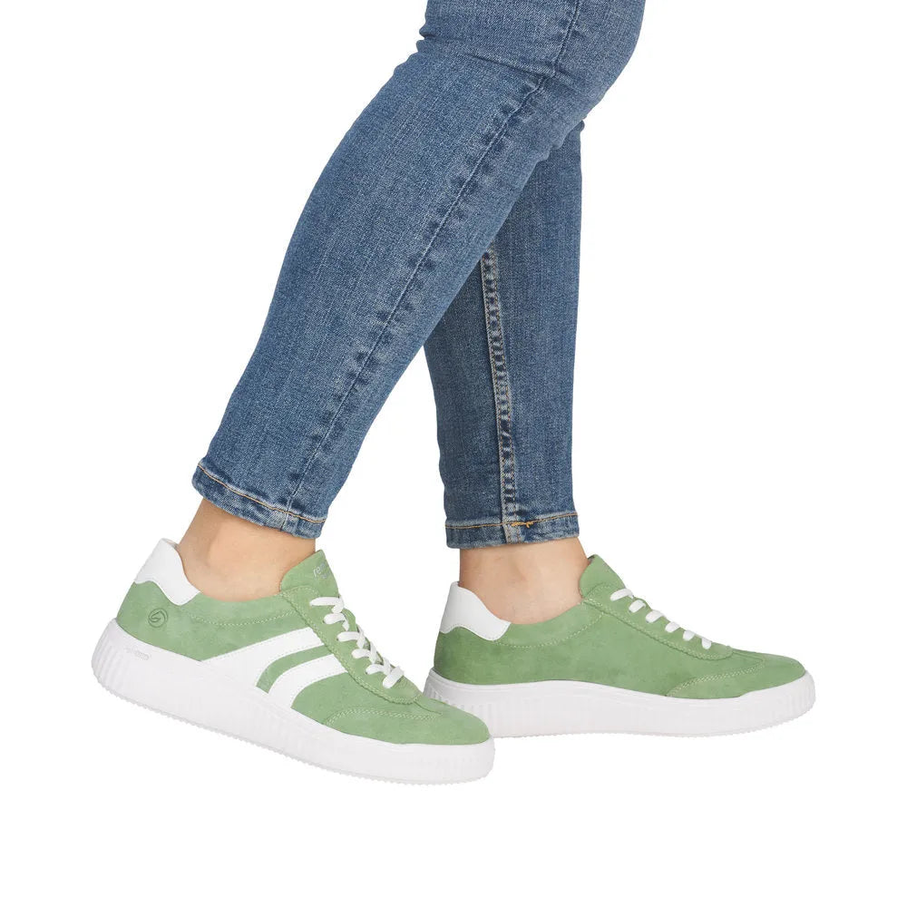 Green suede lace-up shoes with white accents, white sole, and casual style.