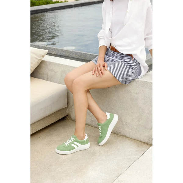 Ladies wide-fit green suede lace-up shoes, casual style, with white soles and detailing.
