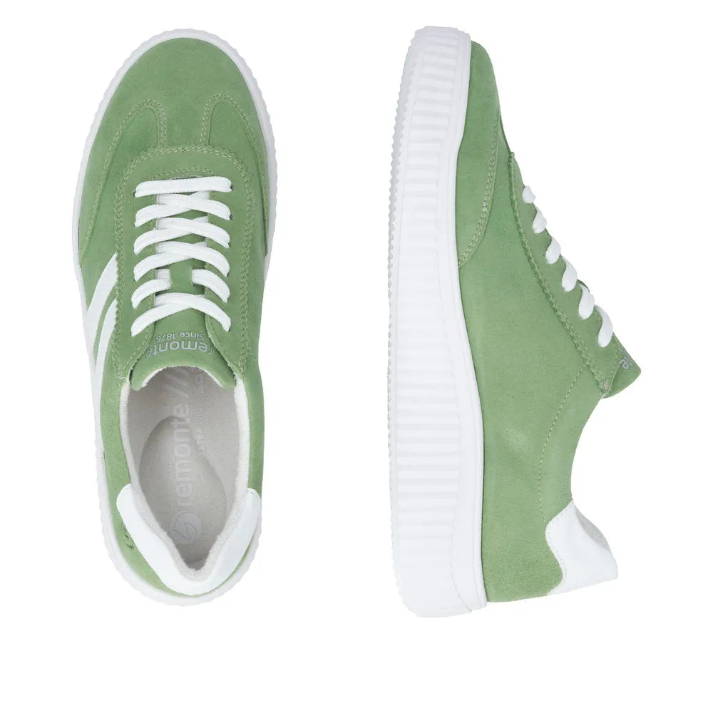 Green suede lace-up shoes with white accents and chunky soles for women.