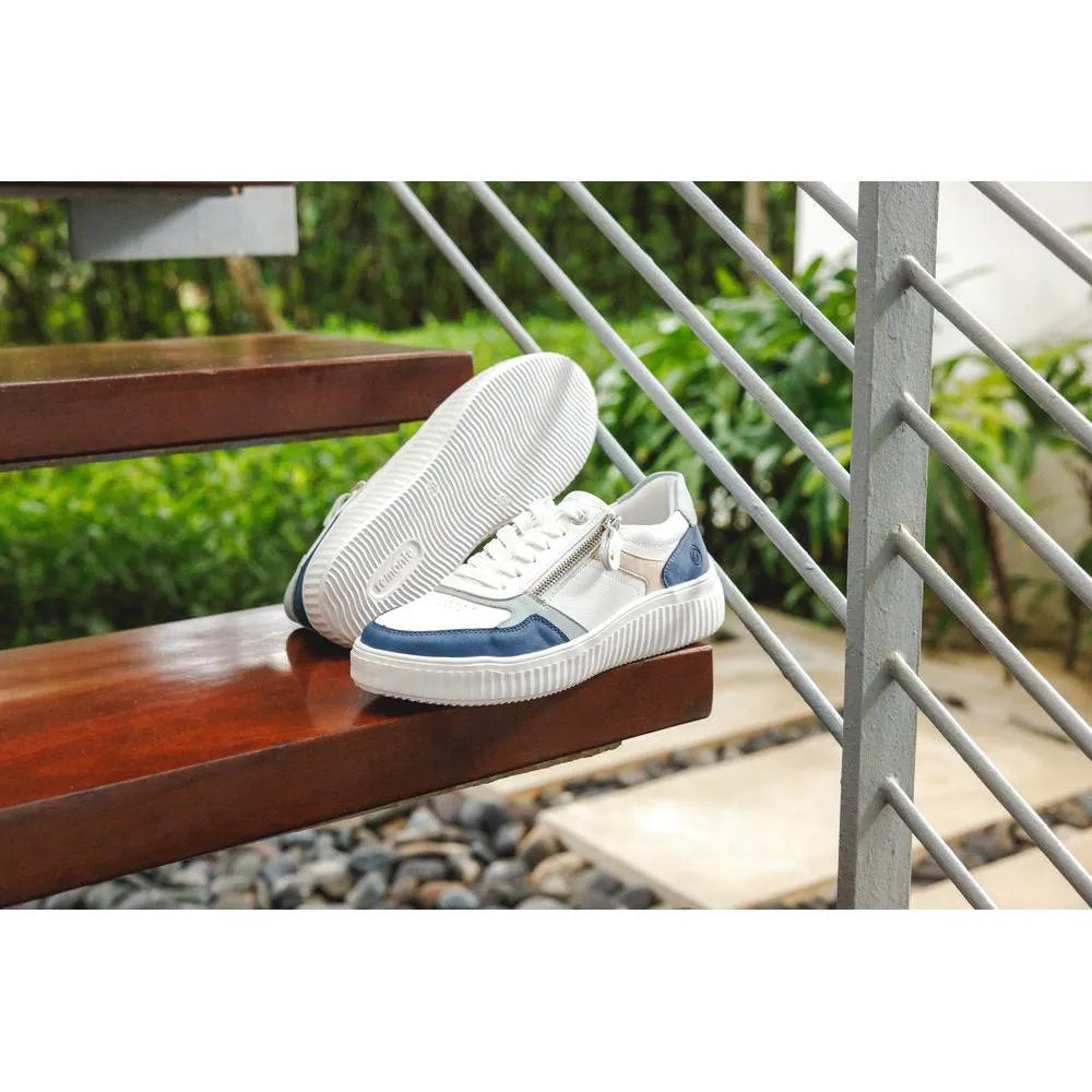 Remonte D3E05-80 women's wide multi leather sneakers with zippers, laces, and white and navy accents, on a wooden bench.