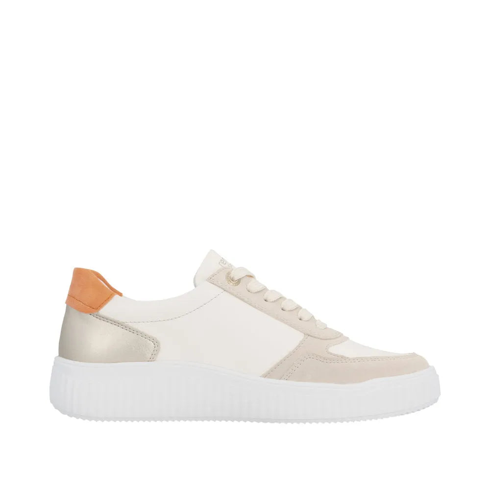Wide fit ladies' sneaker in beige and white leather with lace-up design and contrasting orange heel tab.
