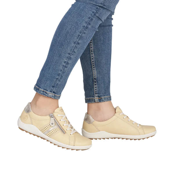 Remonte R1432-69 women's yellow leather shoes with zip, lace-up design, and silver accents, paired with blue jeans.