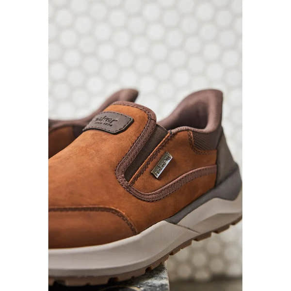 Rieker 06052-22 men's brown suede slip-on shoes with water resistance and cushioned sole.