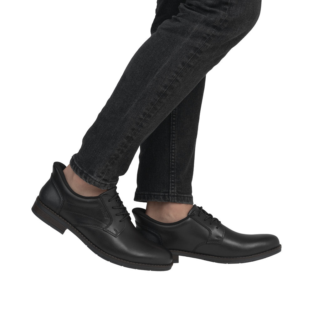 Rieker 10353-00 men's wide fit black leather slip-on shoes with rounded toe and low heel.