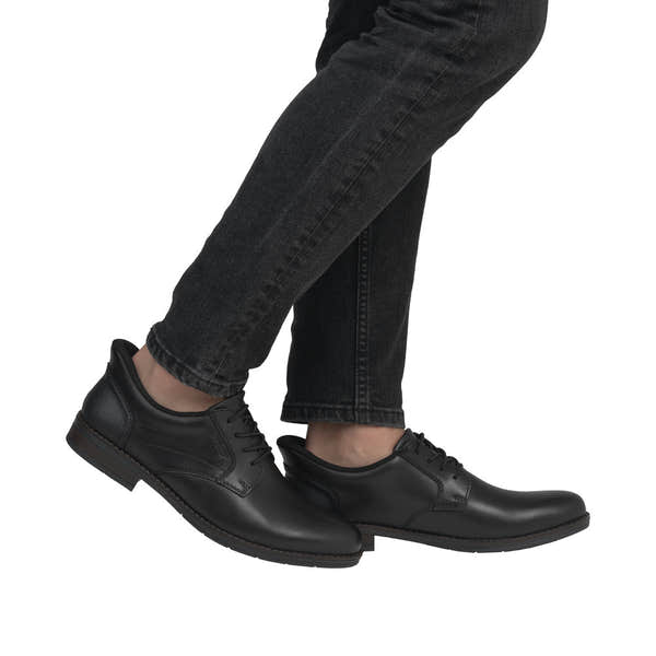 Rieker 10353-00 men's wide fit black leather slip-on shoes with rounded toe and low heel.