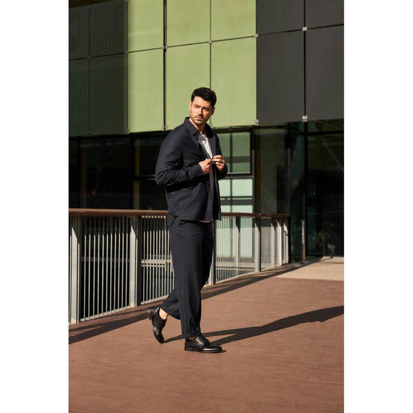 Rieker 10353-00 men's wide black leather slip-on shoes, stylish and comfortable for formal or casual wear.