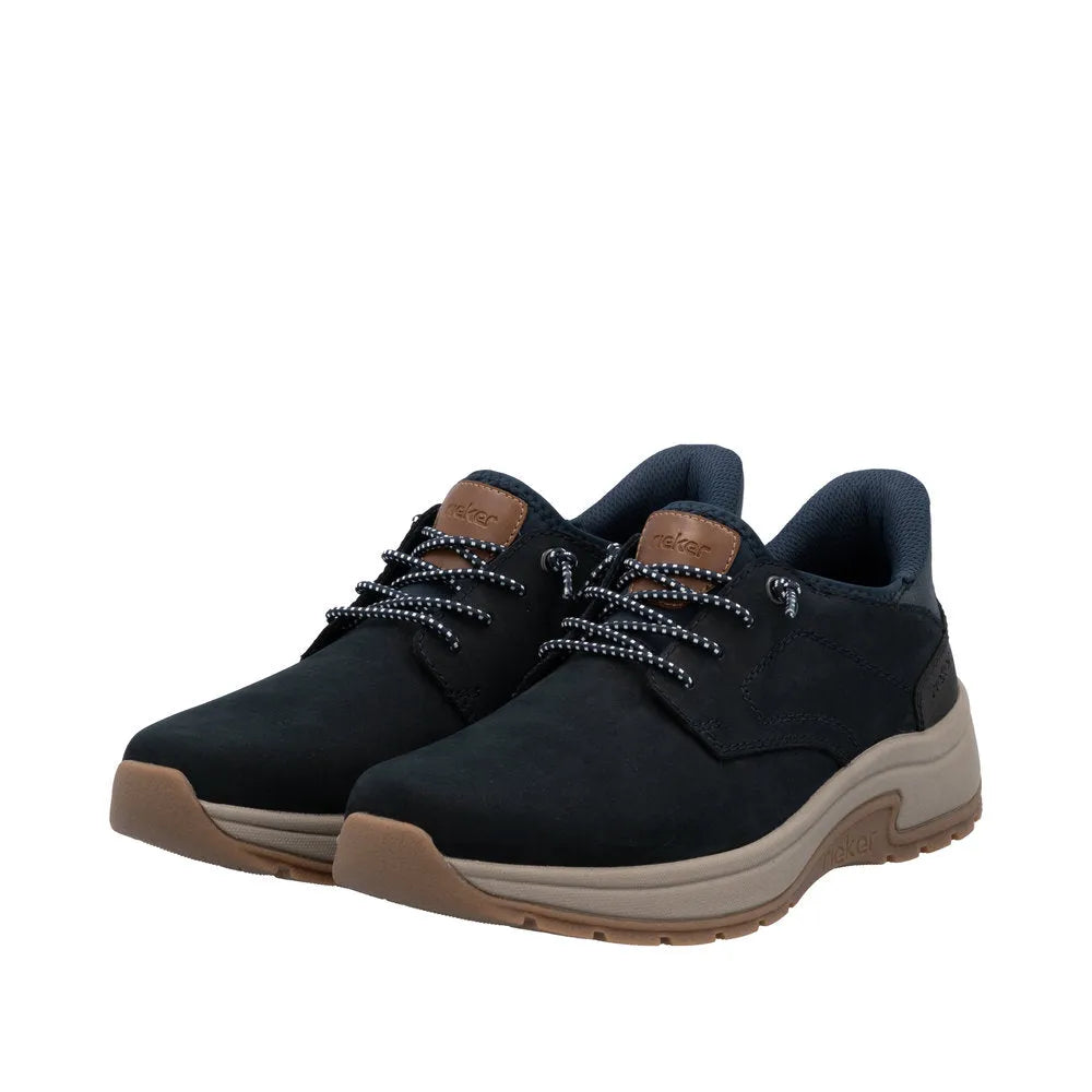 Rieker 11050-14 men's wide fit blue suede slip-on shoes with black and white laces, cushioned collar, and beige rubber sole.
