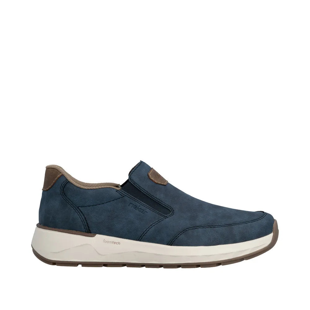 Blue denim slip-on men's shoes with brown accents and a white foam sole.