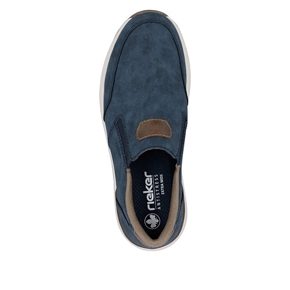 Blue slip-on men's shoes with tan accents, suede and fabric materials, and a white sole.