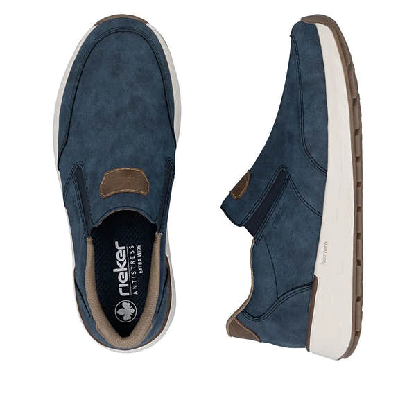 Blue denim-style slip-on shoes for men with brown accents, white sole, and foamtech cushioning, wide fit.