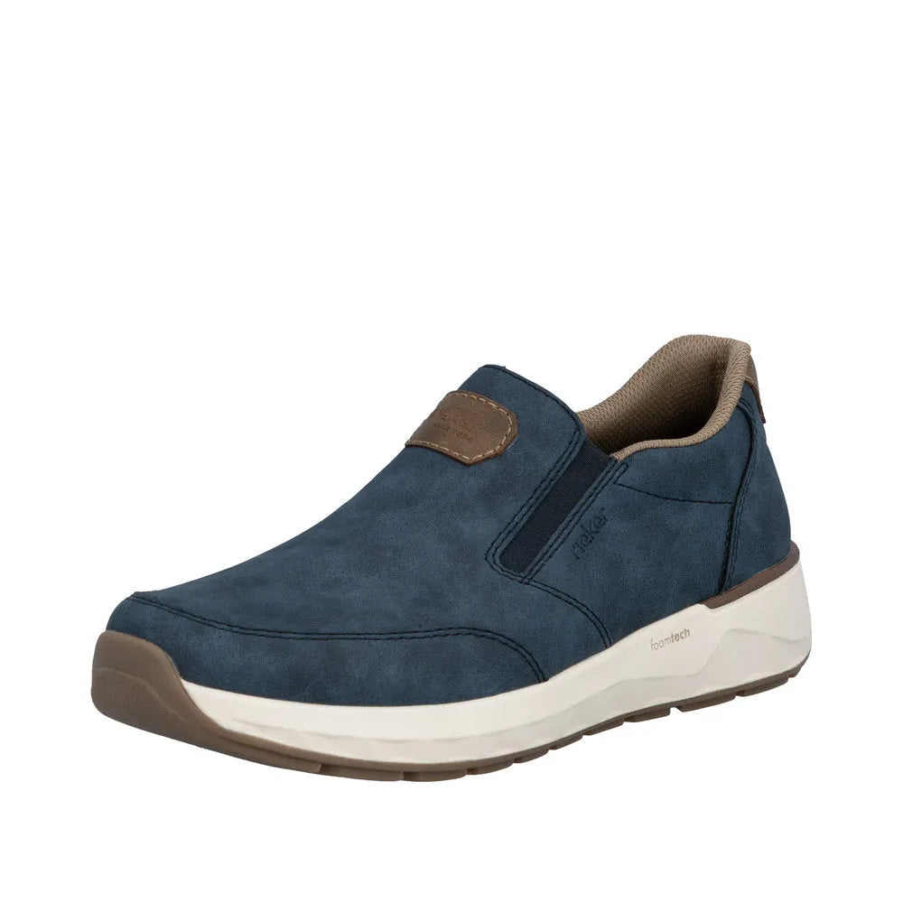 Blue slip-on men's shoes with suede material, brown accents, and a white foam sole.