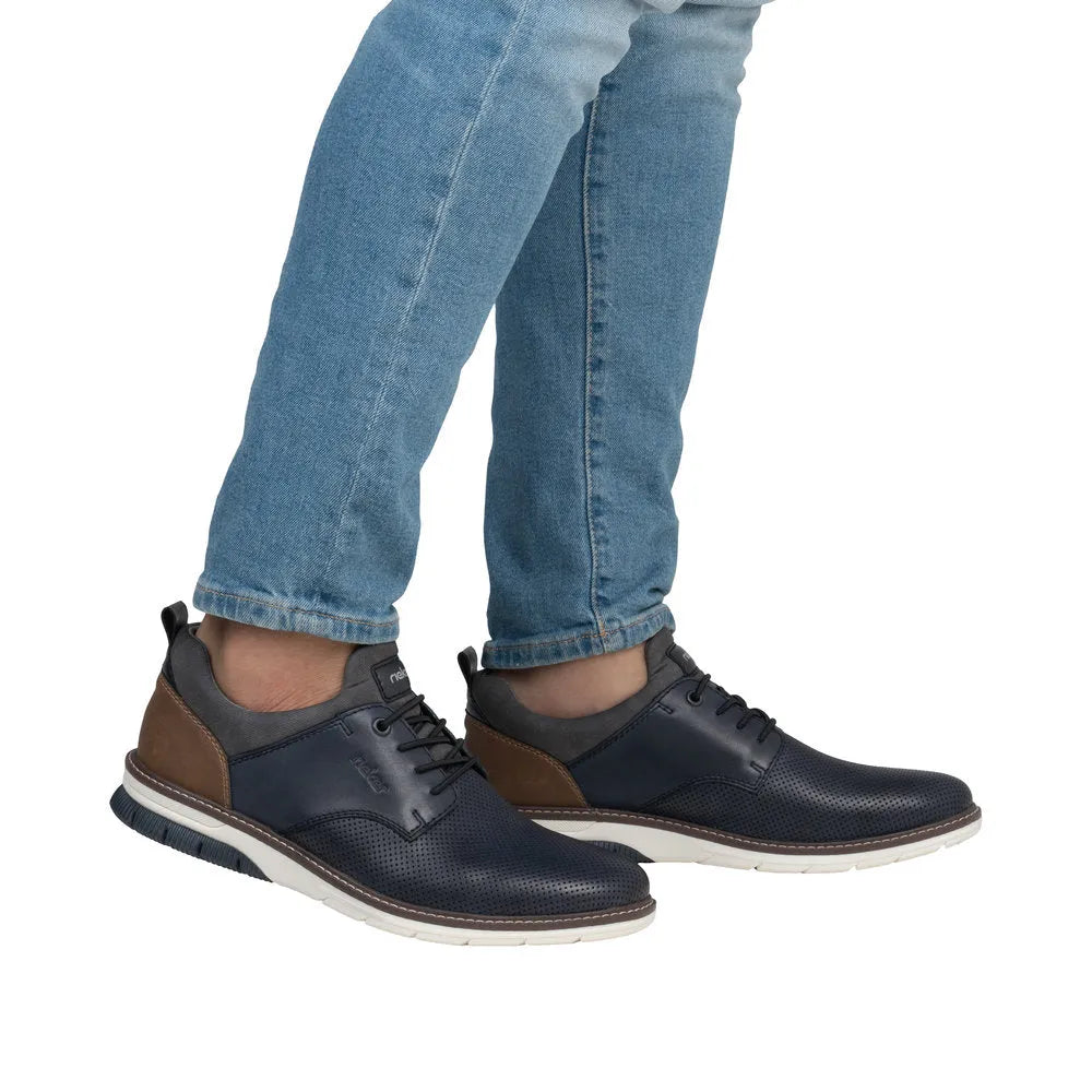 Rieker 14450-15 men's navy and brown leather slip-on shoes with white sole and perforated detail.