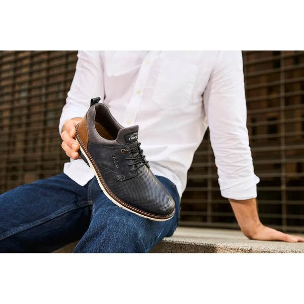 Men's navy and brown leather slip-on shoes by Rieker, stylish casual footwear with perforated detailing and comfortable sole.
