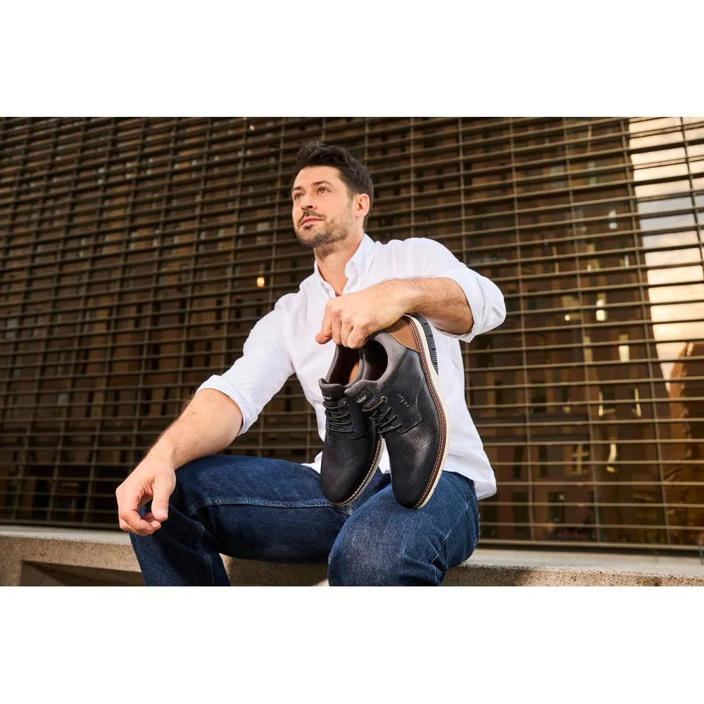 Rieker men's navy and brown leather slip-on shoes, stylish casual footwear with laces and durable design.