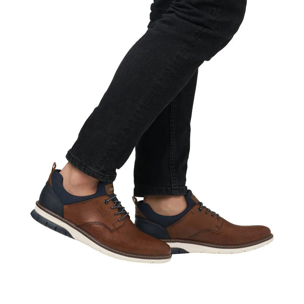 Rieker 14450-22 men's brown and navy leather slip-on shoes with perforated detailing and white rubber sole.