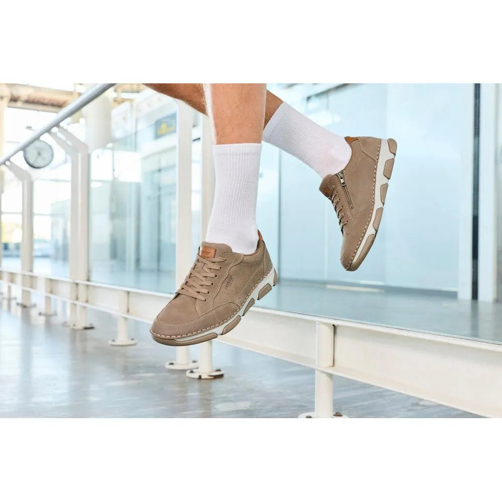 Men's wide brown leather lace-up shoes with white soles, stylish and casual, worn with white socks.