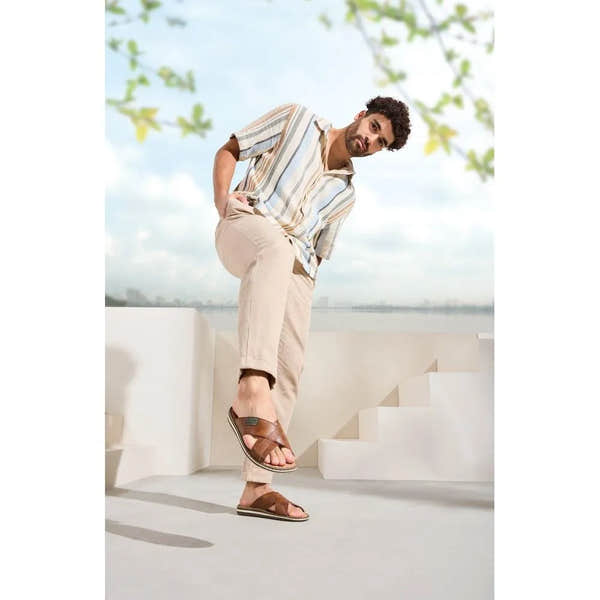 Rieker 21082-24 men's brown leather slip-on sandals, casual open-toe footwear with adjustable straps and cushioned sole.