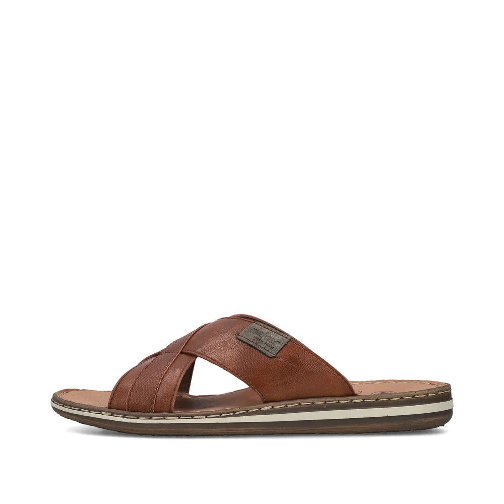 Rieker men's brown leather slip-on sandals with crisscross straps and cushioned footbed for comfort.