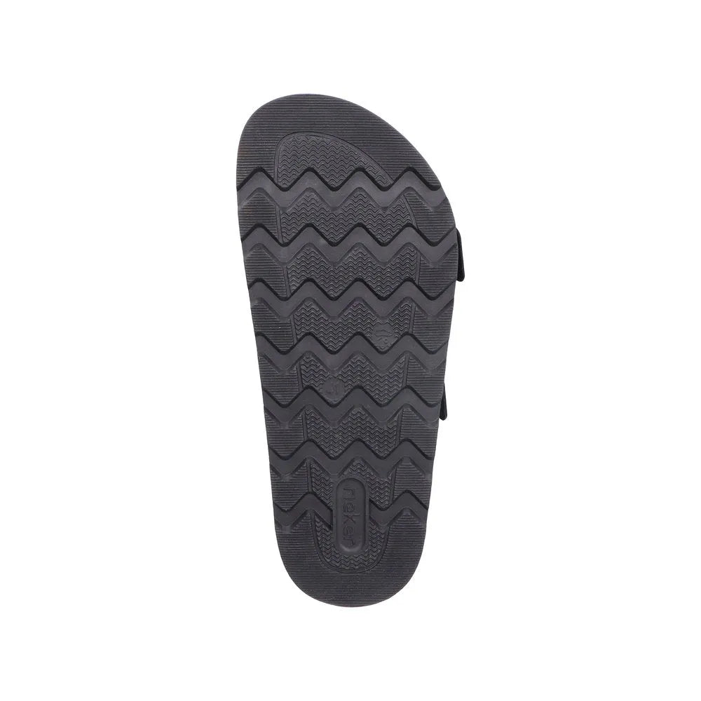 Rieker 21190-00 men's black suede wide-fit mule with buckle, rubber sole, and textured tread pattern.