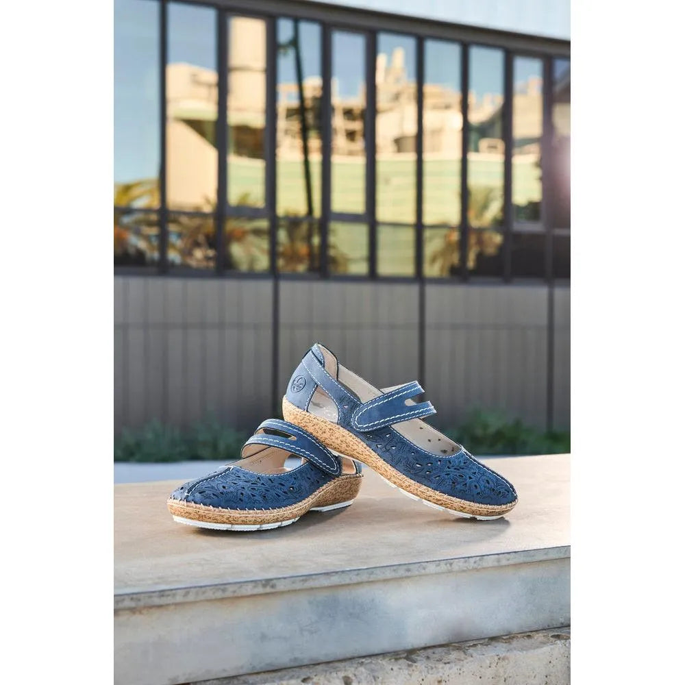 Navy blue women's touch fastening shoes with cutout design, cork-like midsole, and perforated upper on a wooden surface.