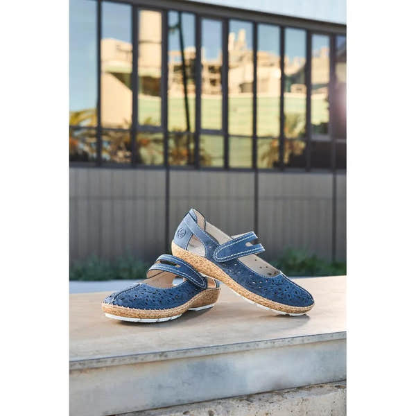 Navy blue women's touch fastening shoes with cutout design, cork-like midsole, and perforated upper on a wooden surface.