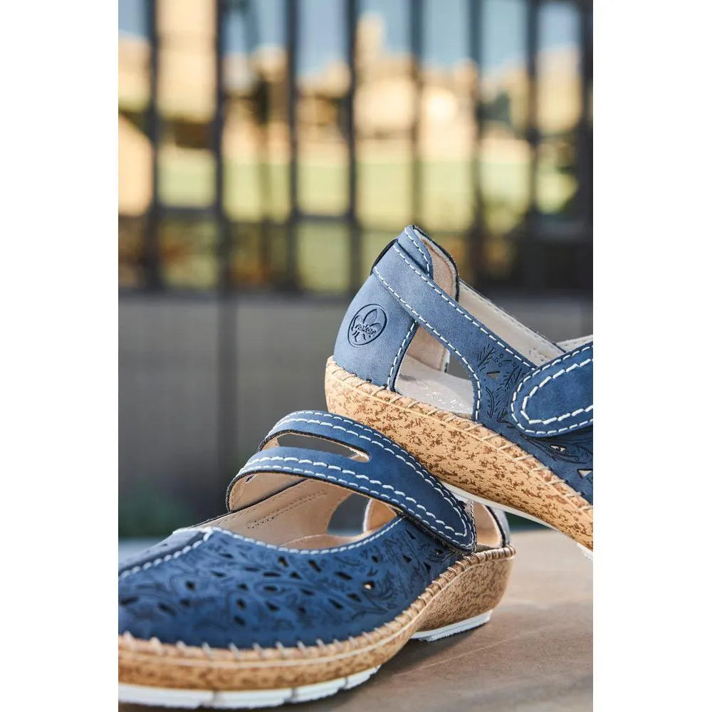 Blue navy touch-fastening sandals with cut-out design, cushioned cork midsoles, white stitching, and velcro straps.