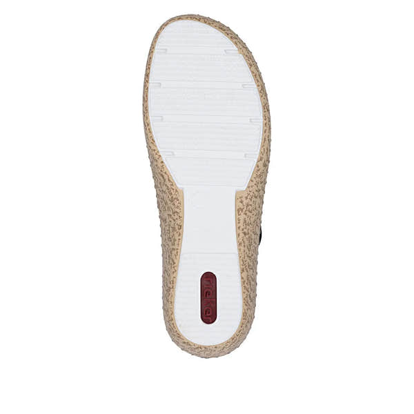 White and beige textured slip-on shoe with touch fastenings, sole with grip pattern, and Rieker branding on heel.
