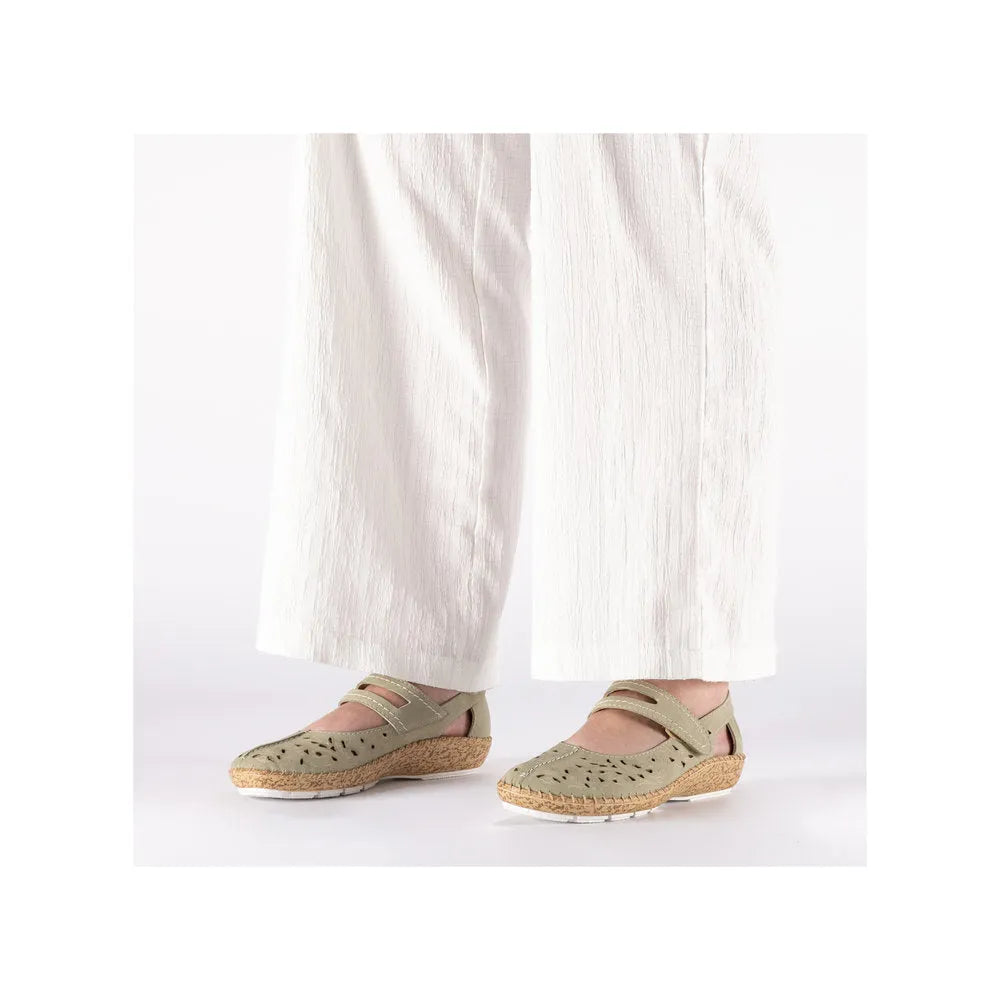 Rieker 44872-52 ladies green touch-fastening shoes with perforated upper, cork sole, and velcro straps, worn with white wide-leg pants.