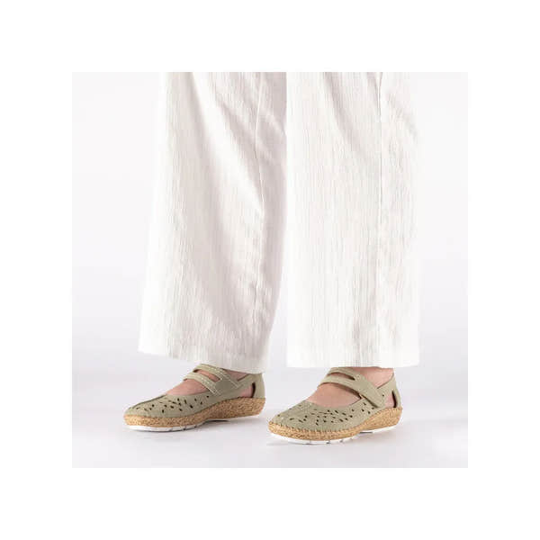 Rieker 44872-52 ladies green touch-fastening shoes with perforated upper, cork sole, and velcro straps, worn with white wide-leg pants.