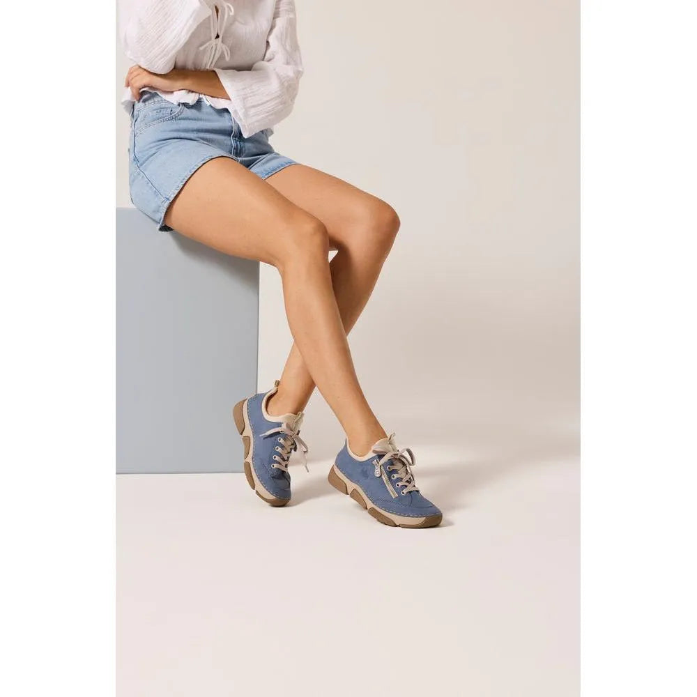 Light blue lace-up shoes with beige accents, chunky soles, and a casual style worn with denim shorts.
